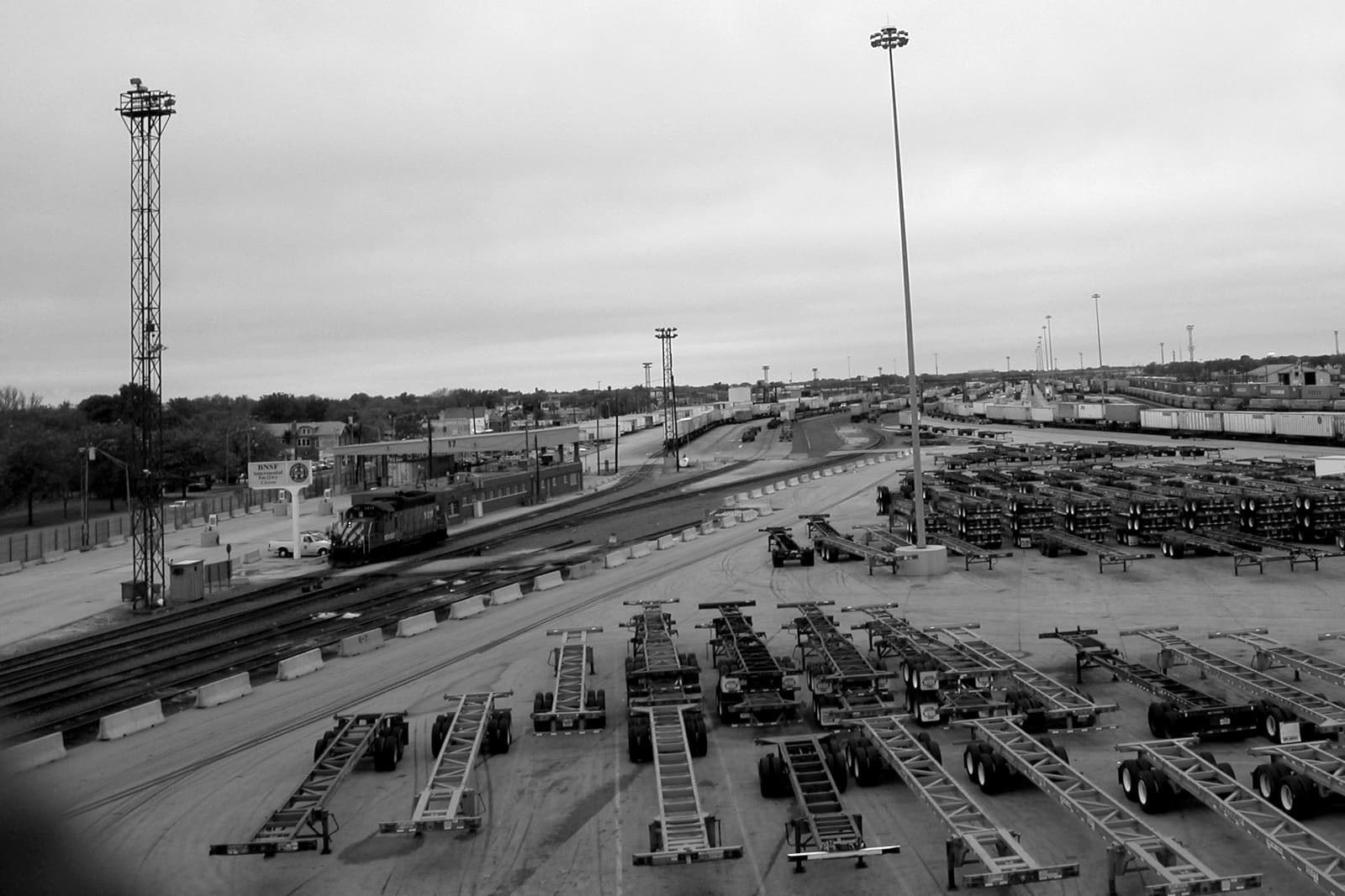 Rows of container chassis and stacked intermodal containers at the BNSF rail terminal in Cicero, Illinois, under an overcast sky.